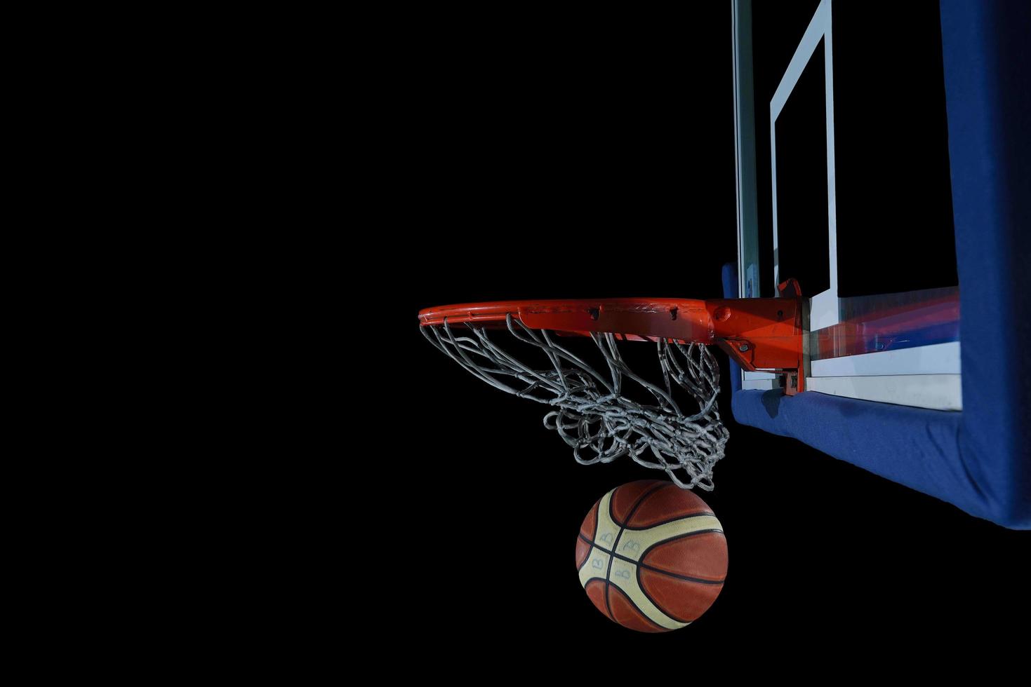 basketball ball and net on black background photo