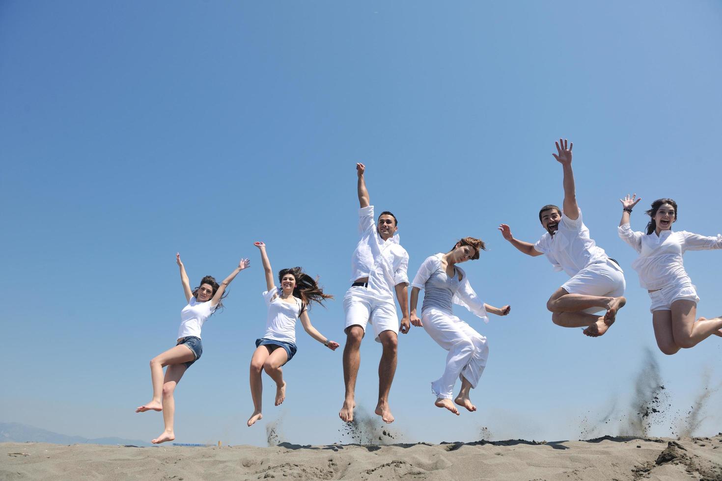 happy people group have fun and running on beach photo