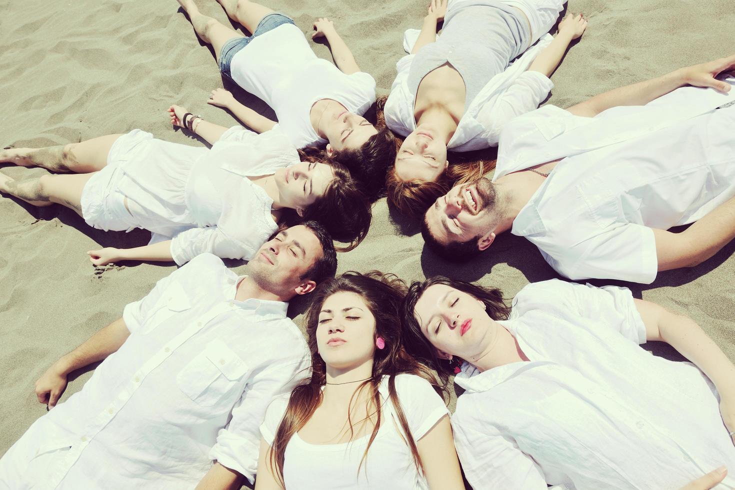 Group of happy young people in have fun at beach photo