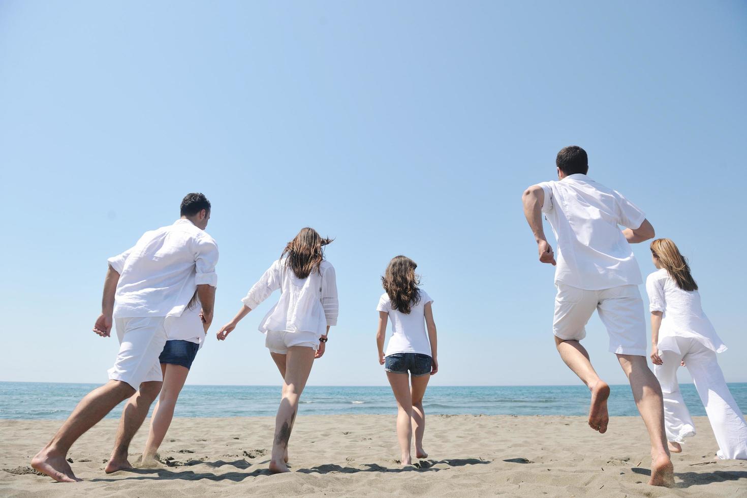 happy people group have fun and running on beach photo