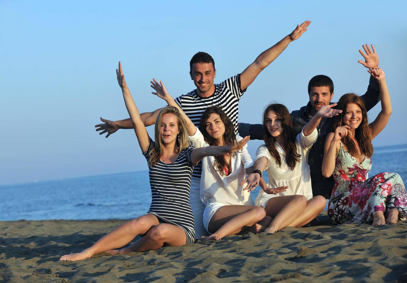 happy young  people group have fun on beach photo