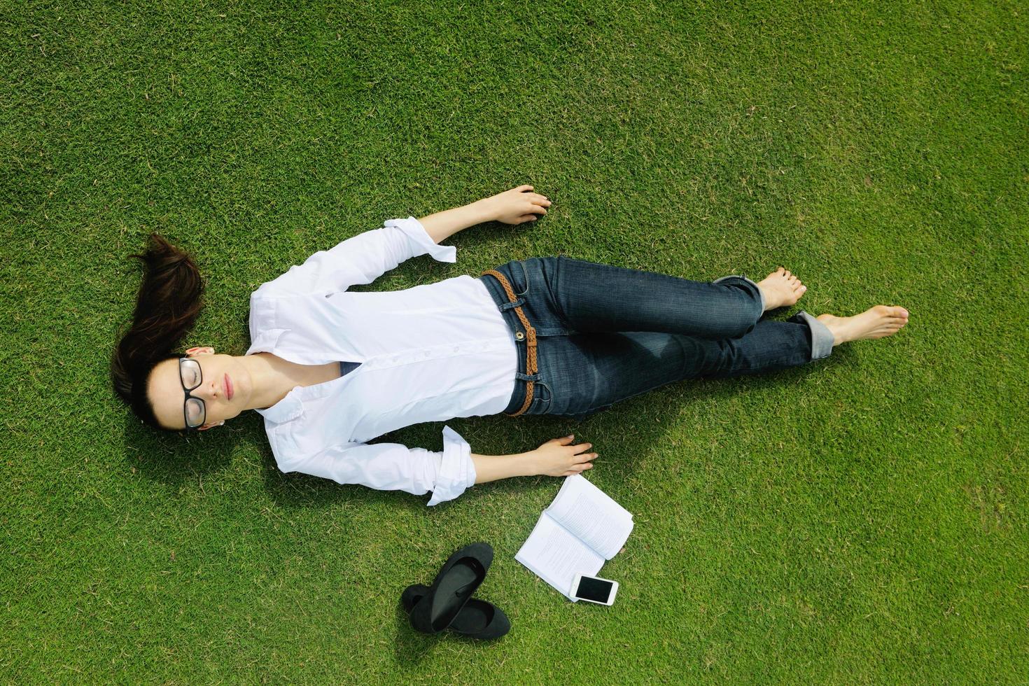 Young woman reading a book in the park photo