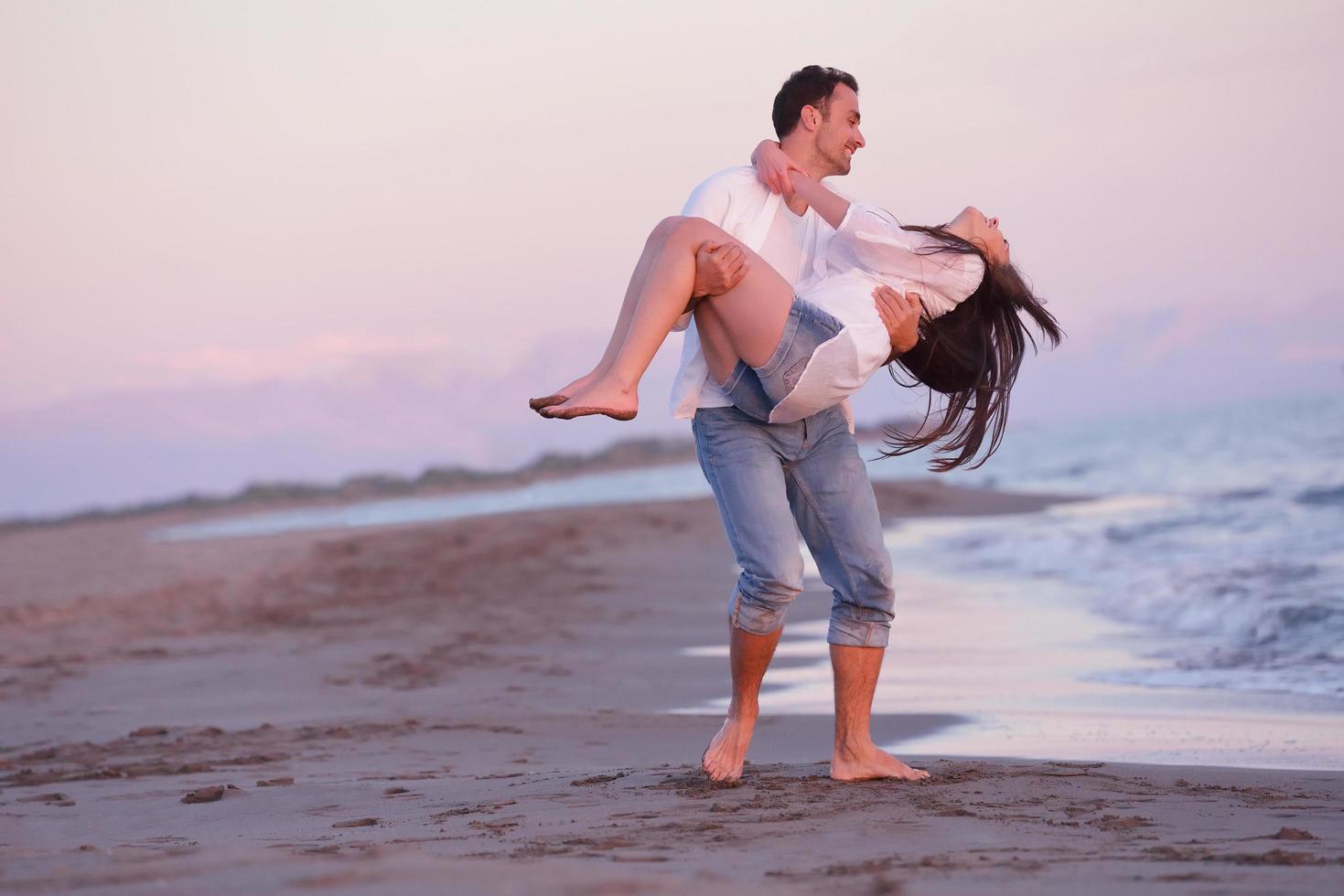young couple  on beach have fun photo