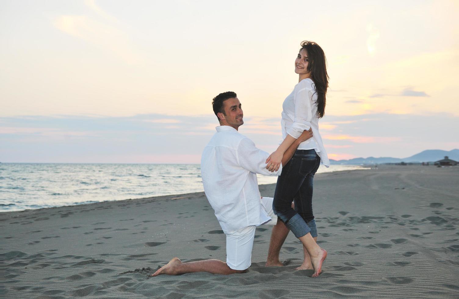happy young couple have fun on beach photo