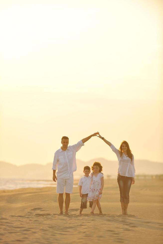 happy young family have fun on beach at sunset photo