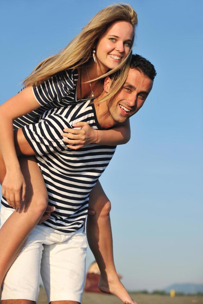 happy young couple have romantic time on beach photo