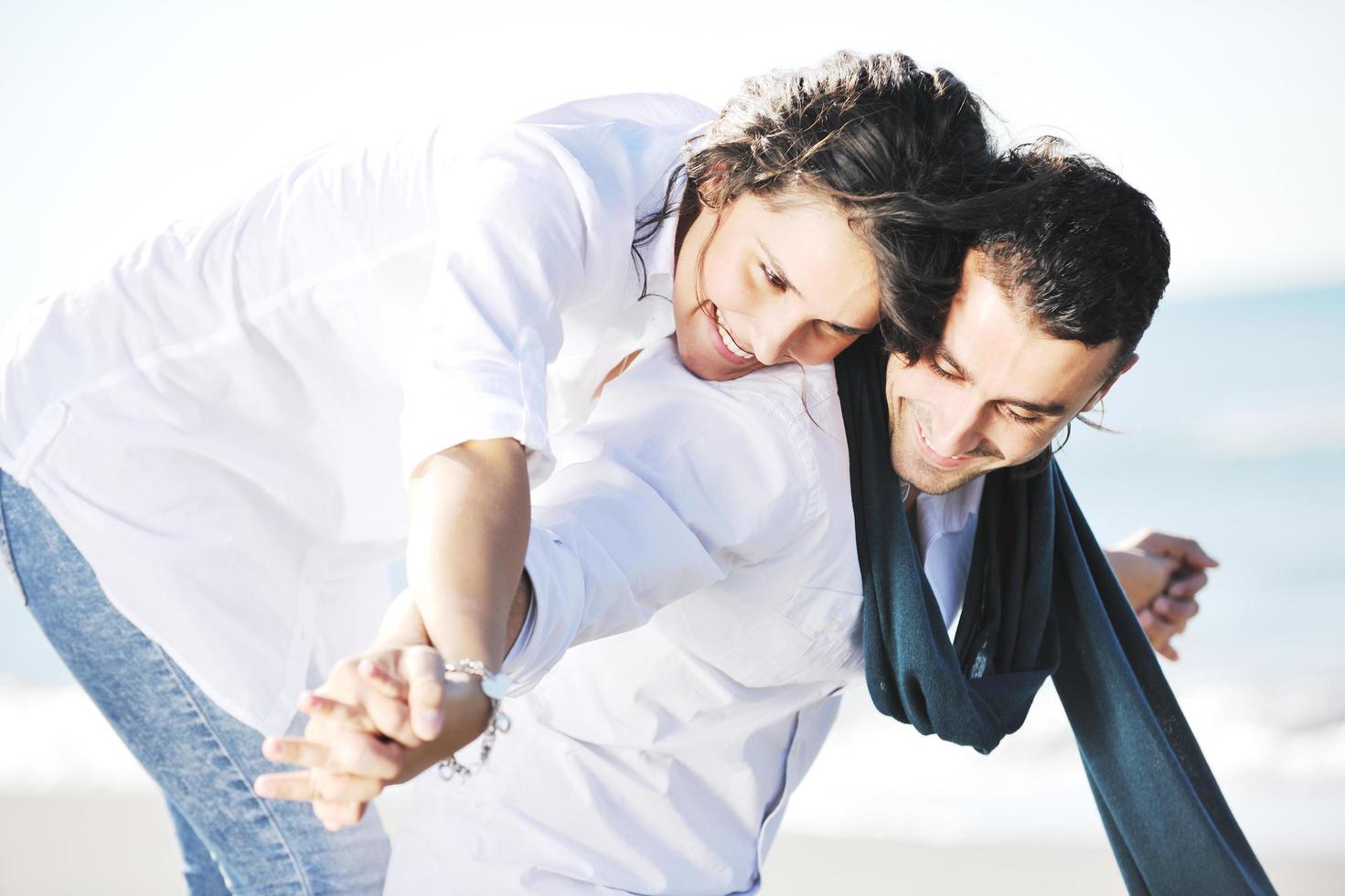 happy young couple have fun at beautiful beach photo