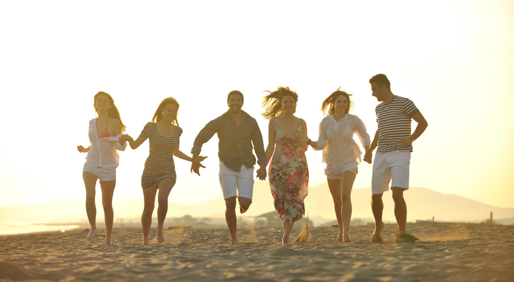 happy young  people group have fun on beach photo