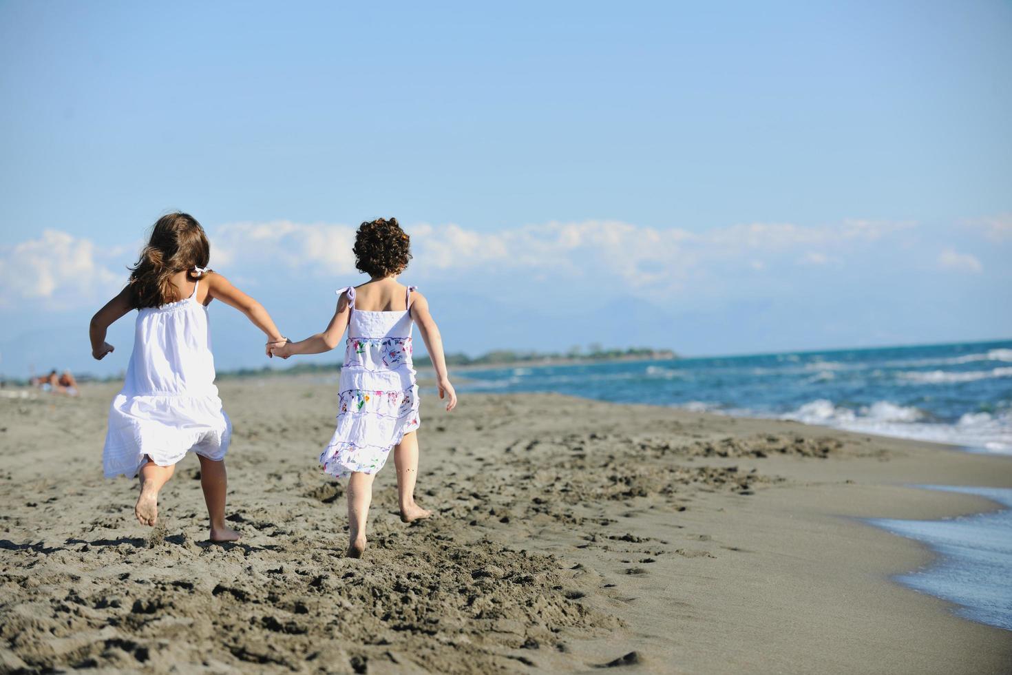 cute little girls running on beach photo