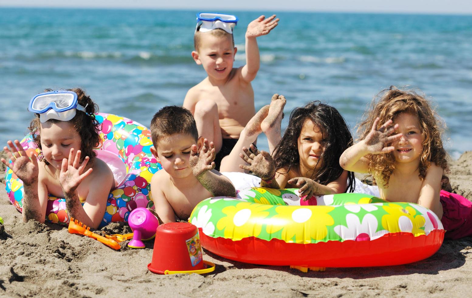 child group have fun and play with beach toys photo