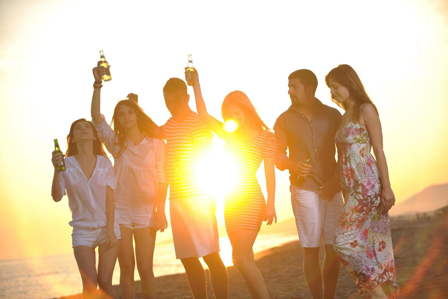 Group of young people enjoy summer  party at the beach photo