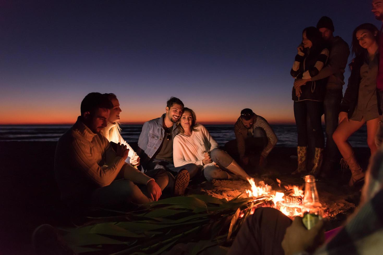 Friends having fun at beach on autumn day photo