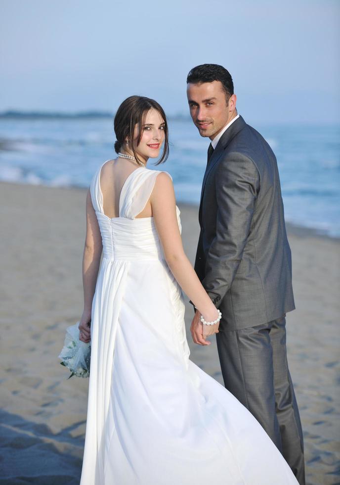 romantic beach wedding at sunset photo