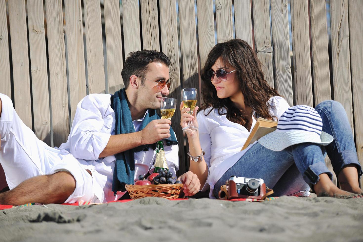 young couple enjoying  picnic on the beach photo
