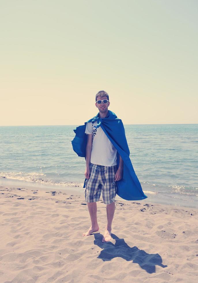 funny superhero standing on beach photo