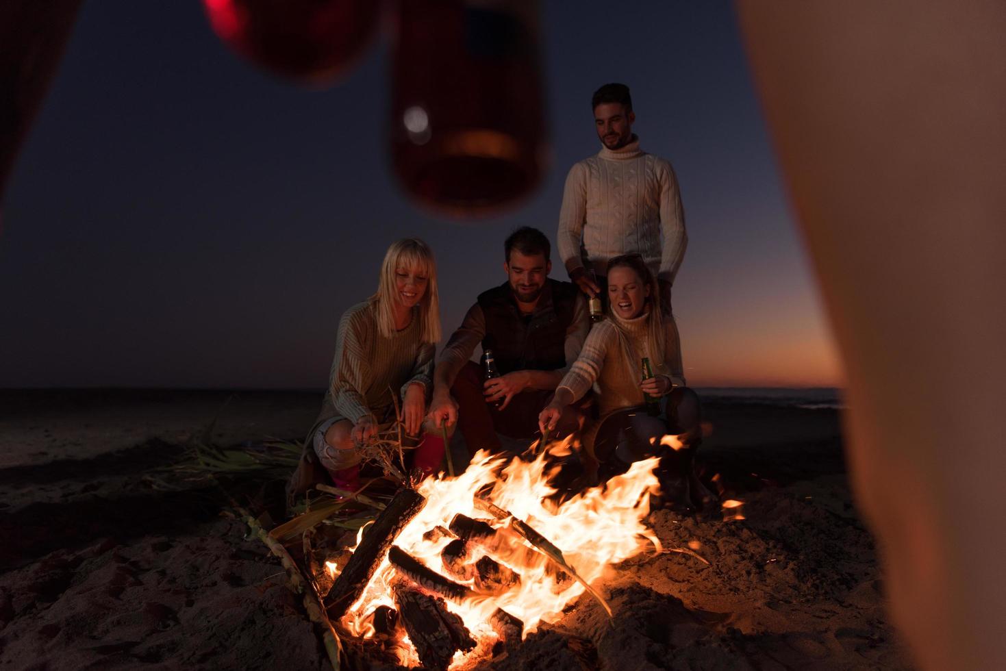 Friends having fun at beach on autumn day photo