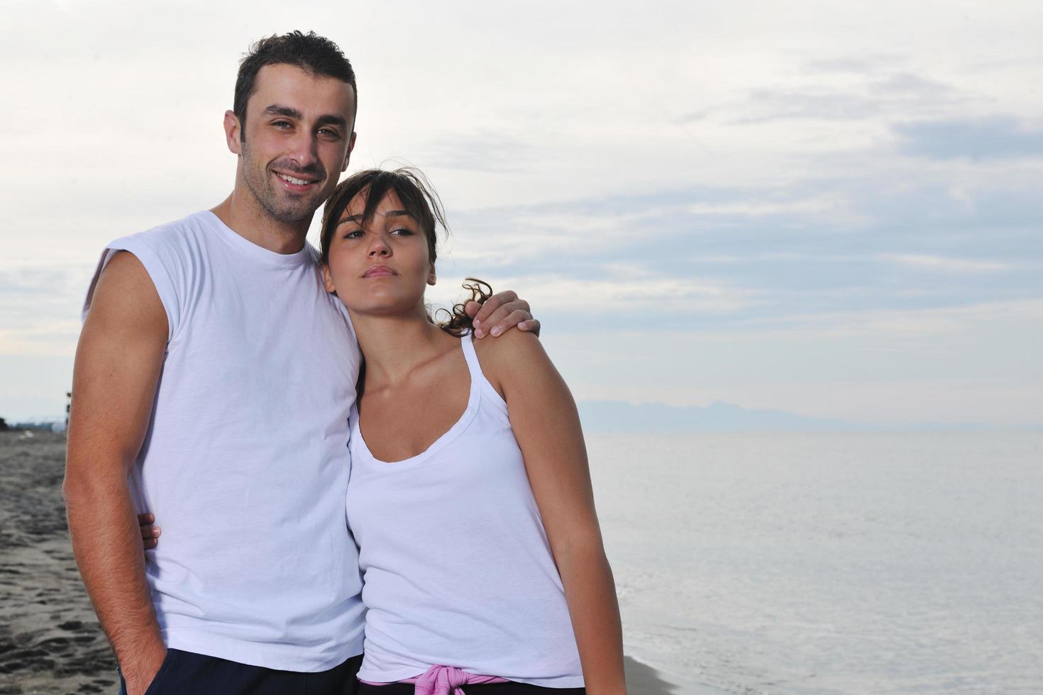 happy young couple have fun at beautiful beach photo