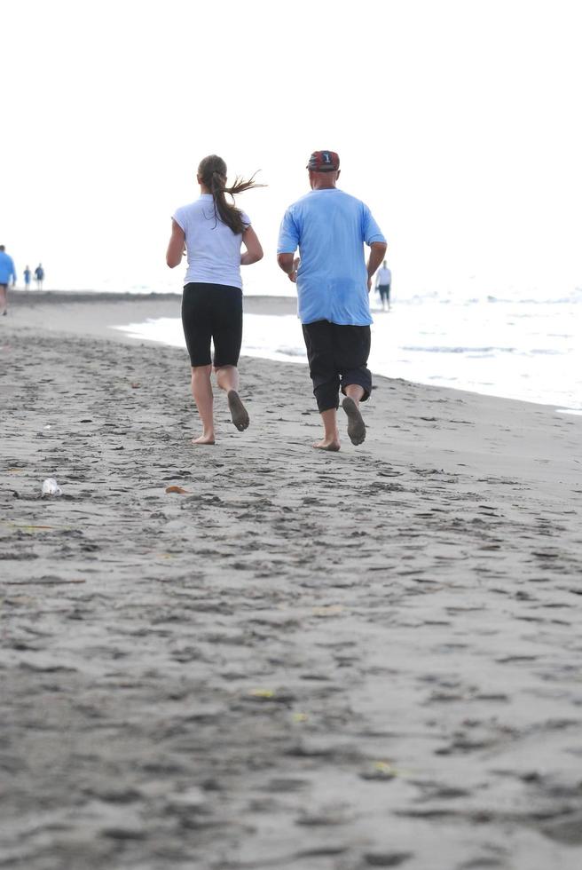 couple running on beach photo