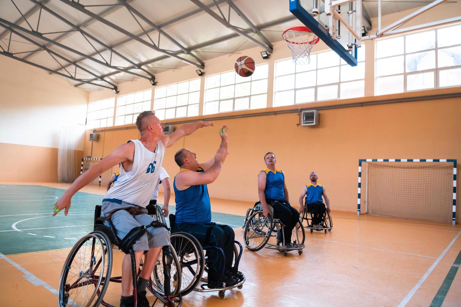 a photo of basketball teams with disabilities with the selector in the big hall before the start of the basketball game