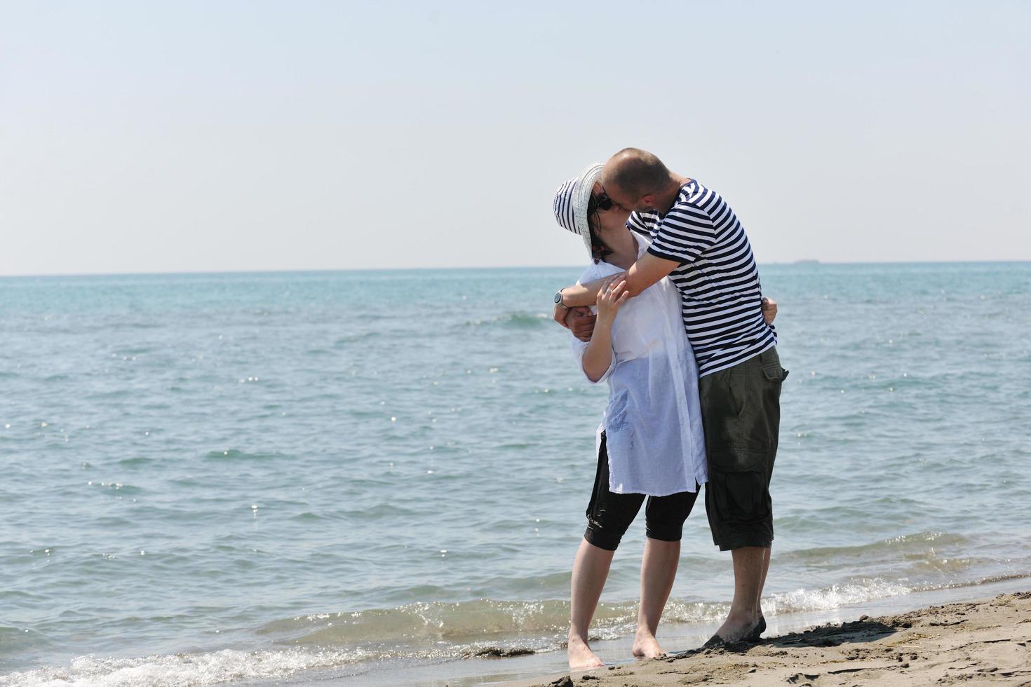 happy young couple have fun on beach photo