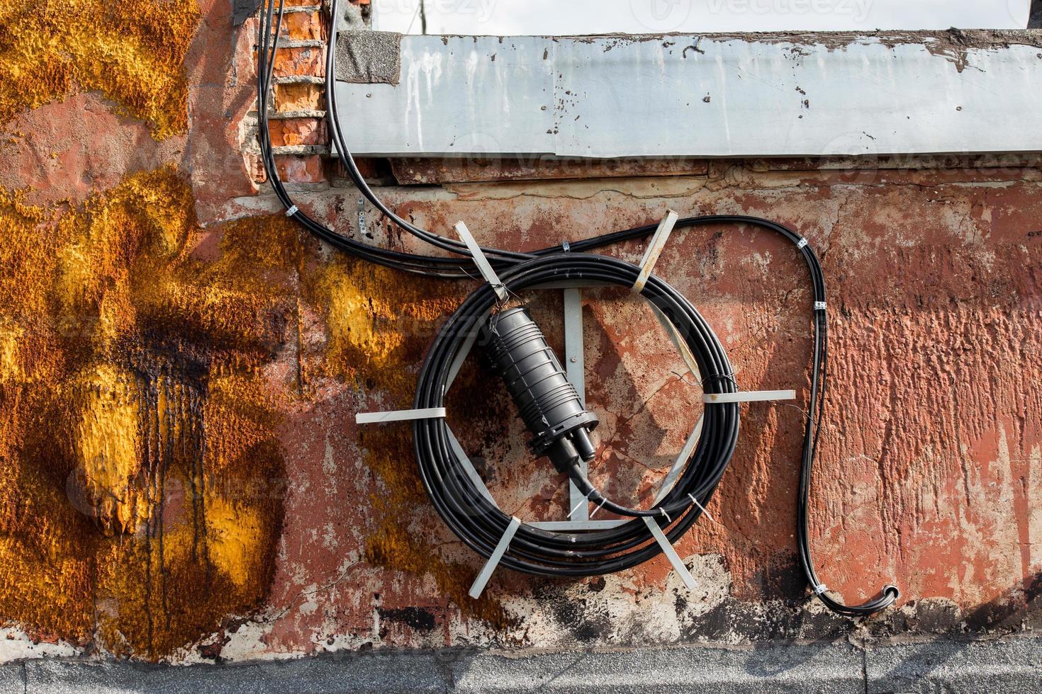 spool of long black wire on the roof of a house somewhere in russia photo