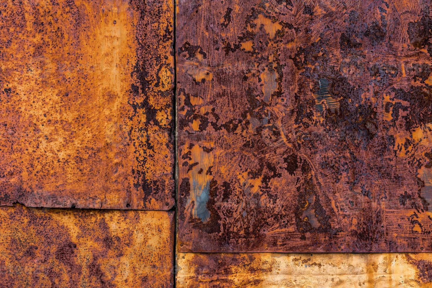Rusted flat composite nailed metal sheets surface background and texture. photo