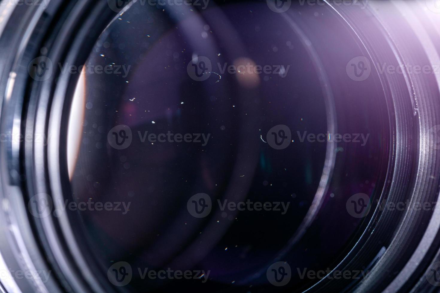 Dust particles in camera lens closeup shot with selective focus and blur. photo