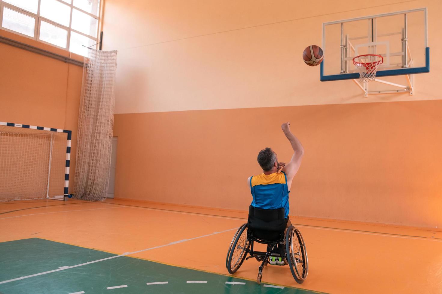 a photo of a war veteran playing basketball in a modern sports arena. The concept of sport for people with disabilities