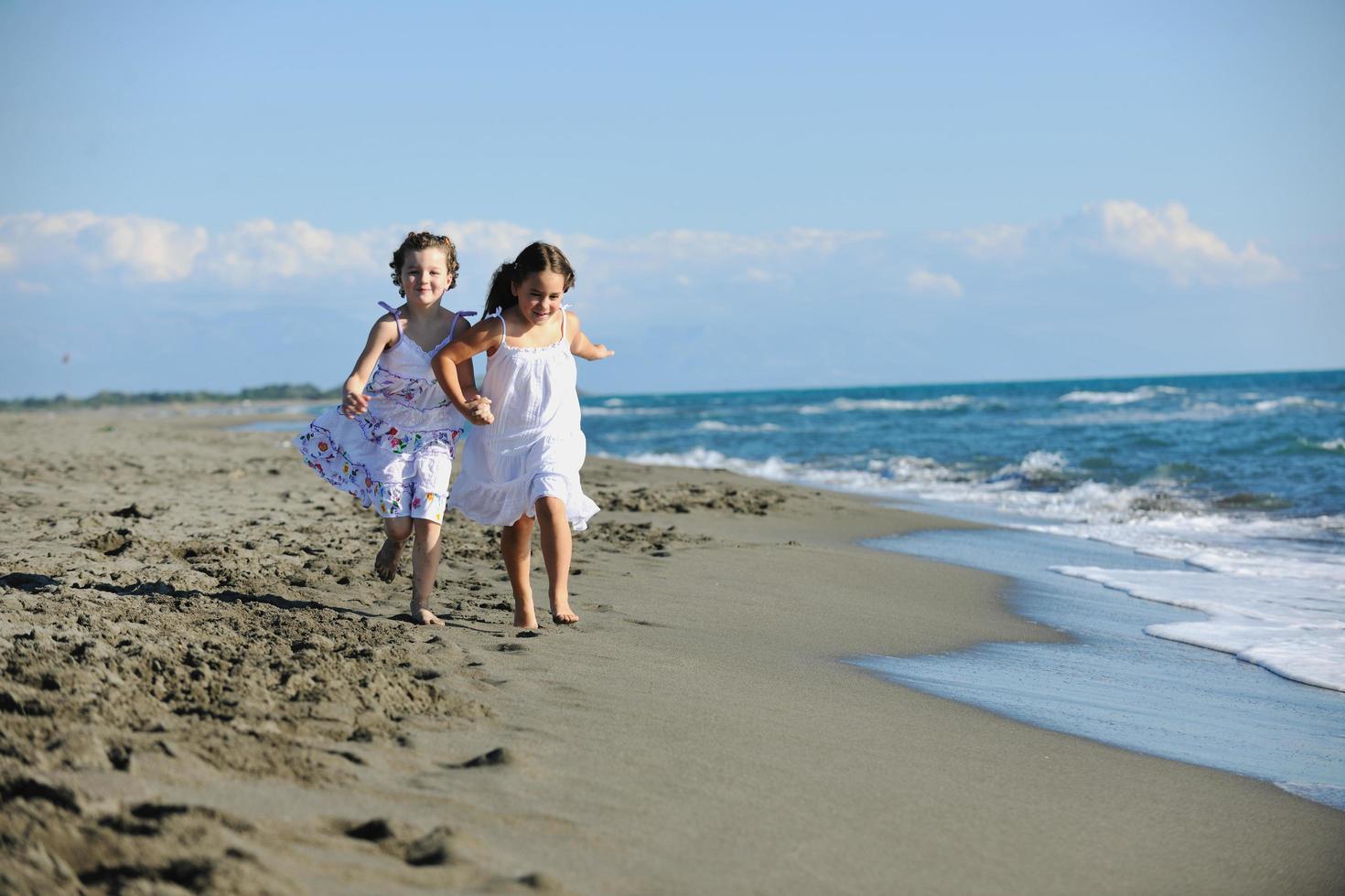 cute little girls running on beach photo