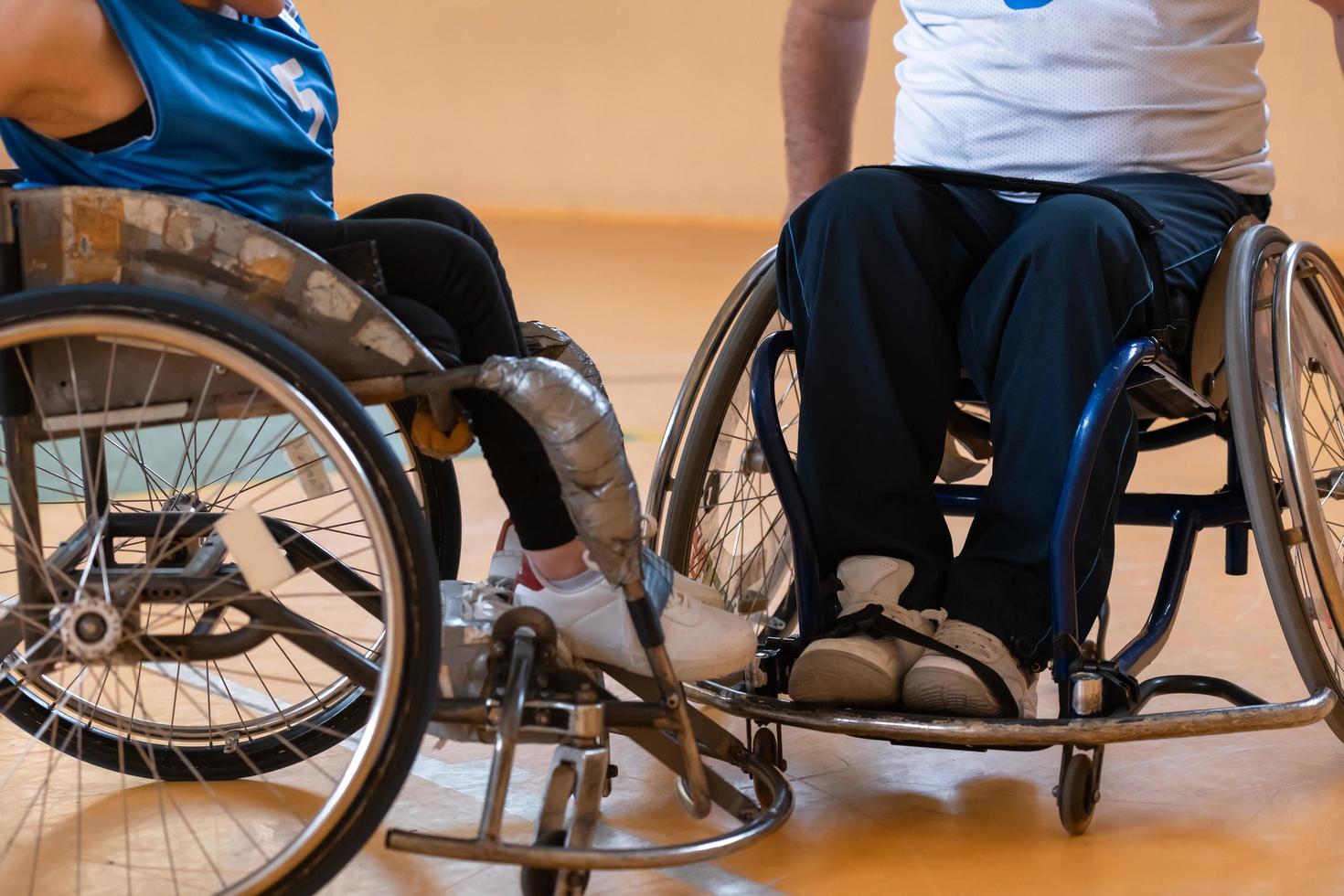 Close up photo of wheelchairs and handicapped war veterans playing basketball on the court