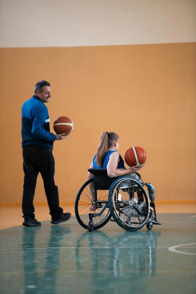 a sports basketball coach explains to a disabled woman in a wheelchair which position to play during a game photo