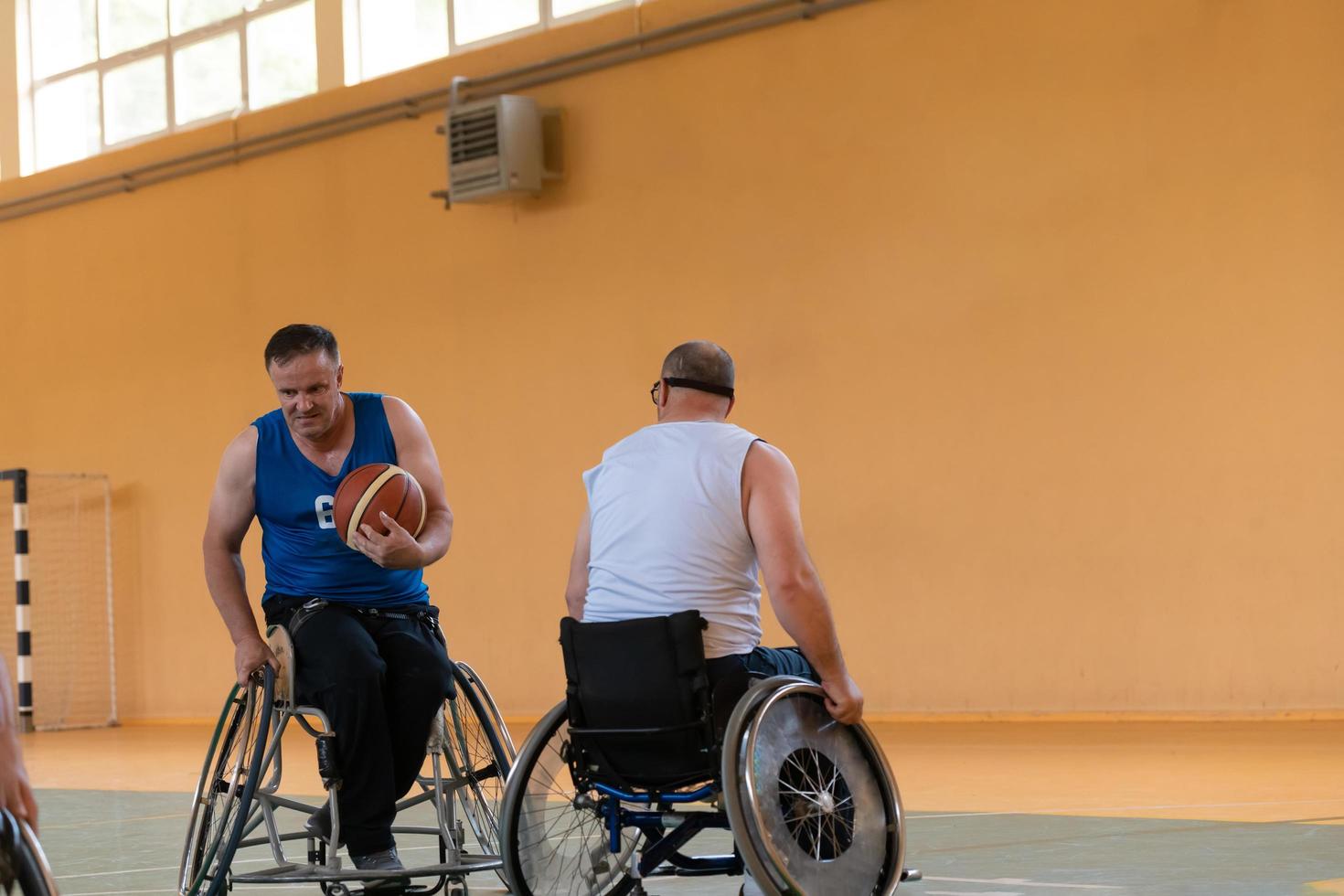 disabled war veterans in action while playing basketball on a basketball court with professional sports equipment for the disabled photo