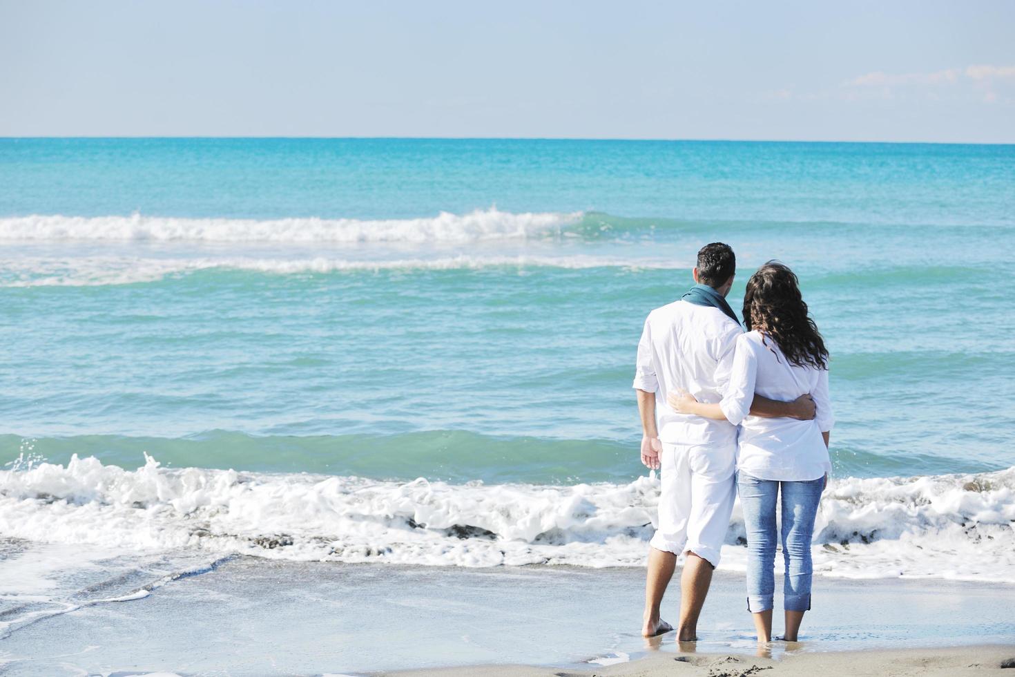 happy young couple have fun at beautiful beach photo