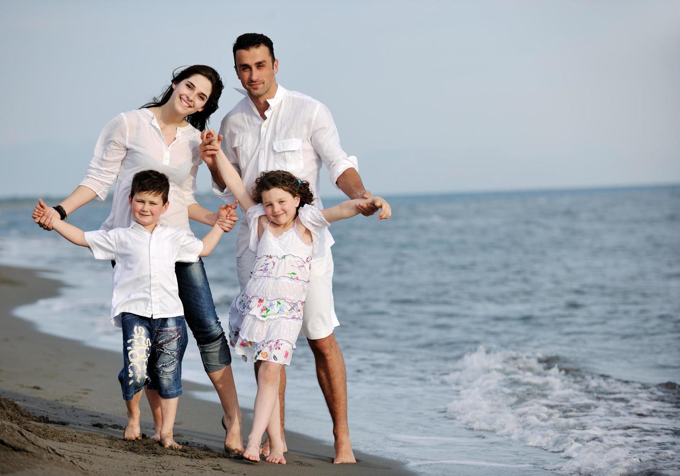 happy young family have fun on beach photo