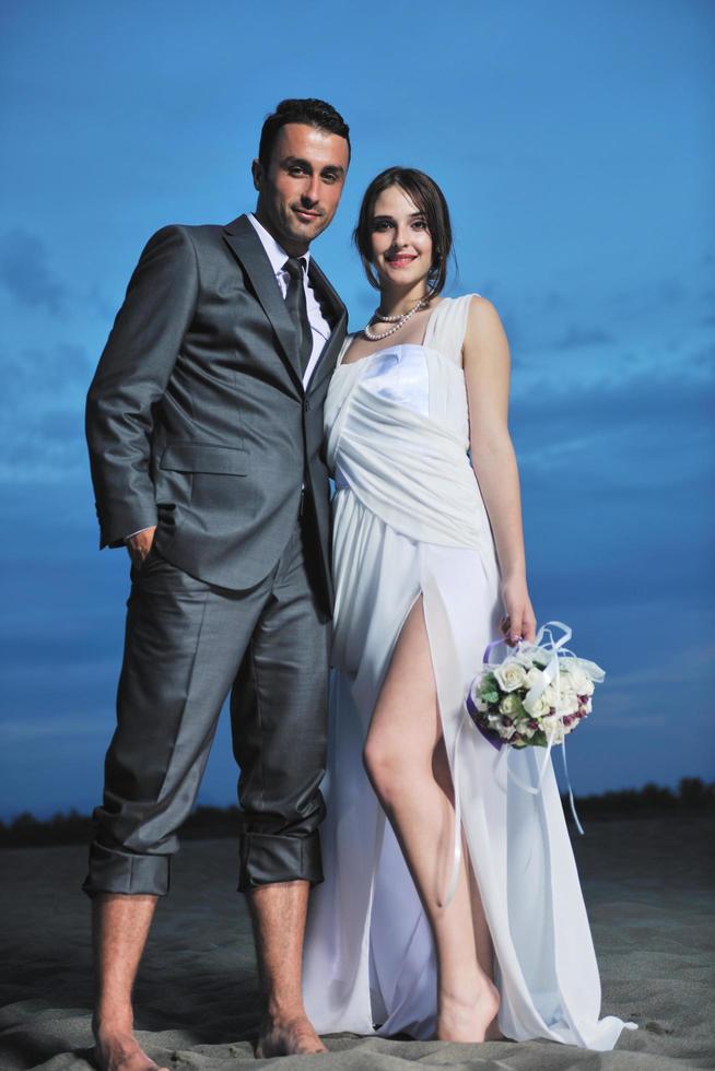 romantic beach wedding at sunset photo