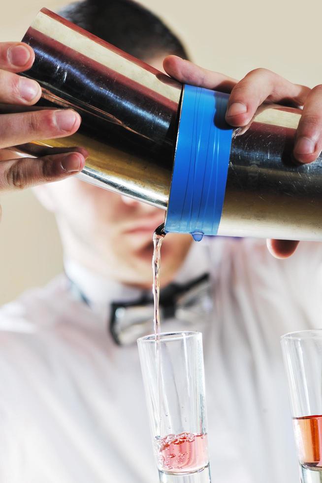 pro barman prepare coctail drink on party photo