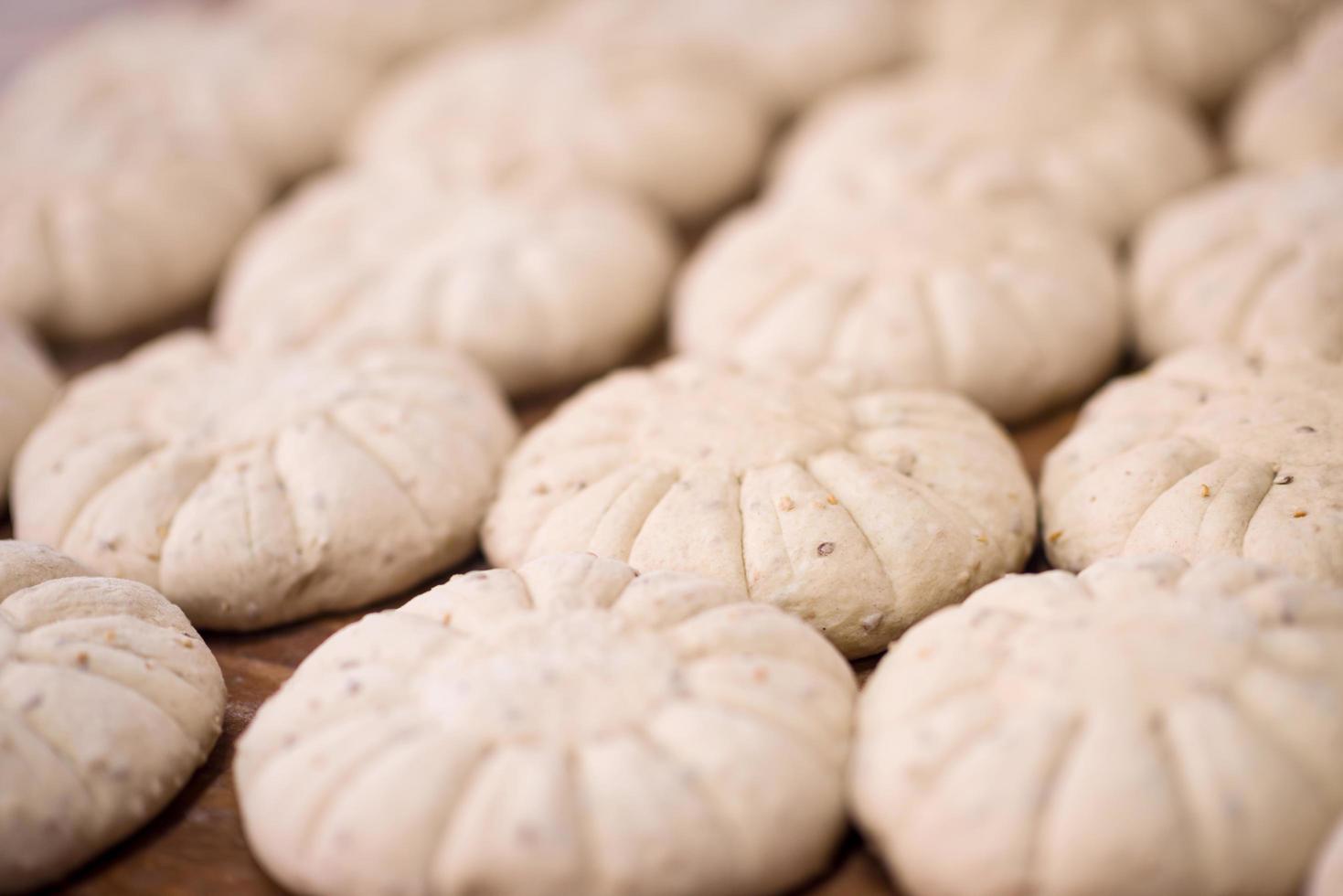 balls of dough bread getting ready to be baked photo