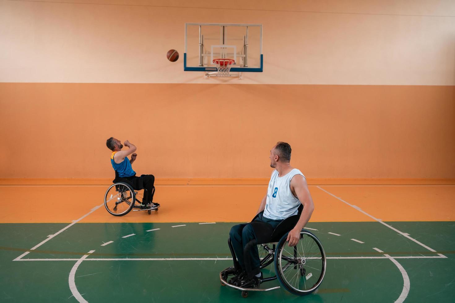 disabled war veterans in action while playing basketball on a basketball court with professional sports equipment for the disabled photo