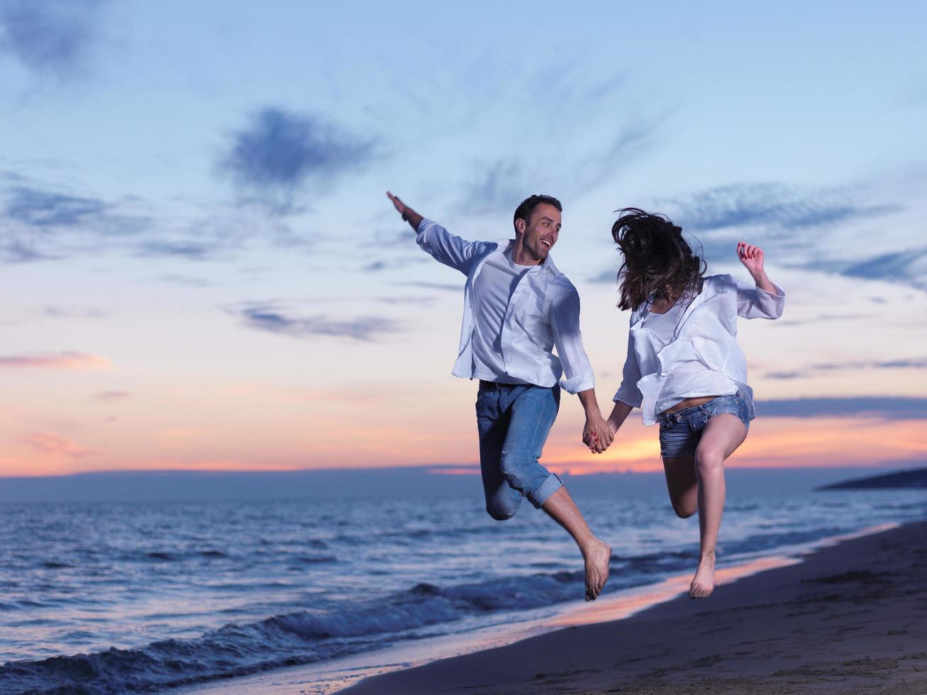 young couple  on beach have fun photo