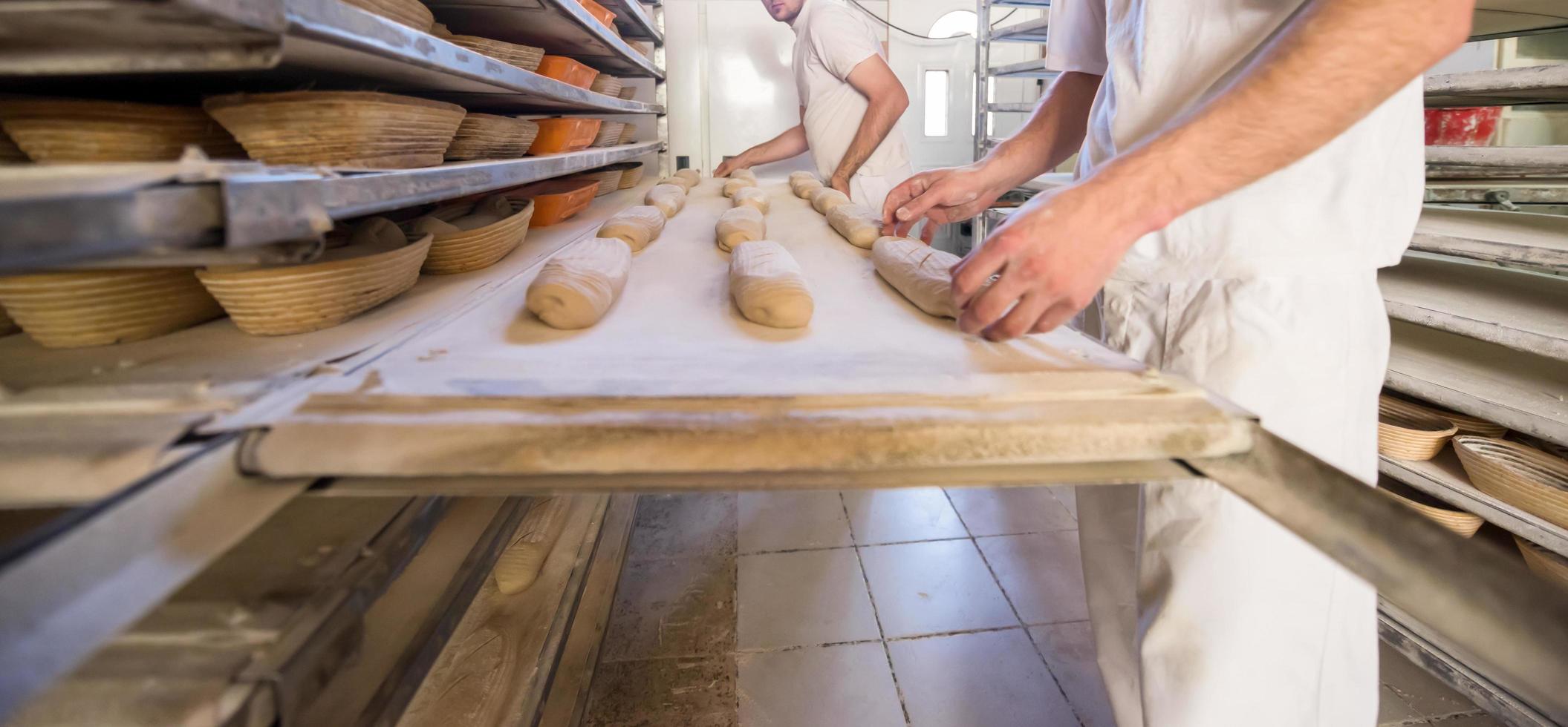 bakers preparing the dough photo