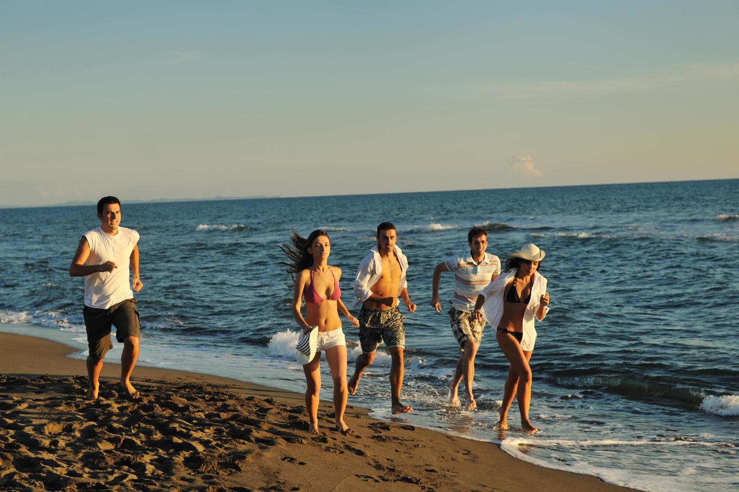 people group running on the beach photo