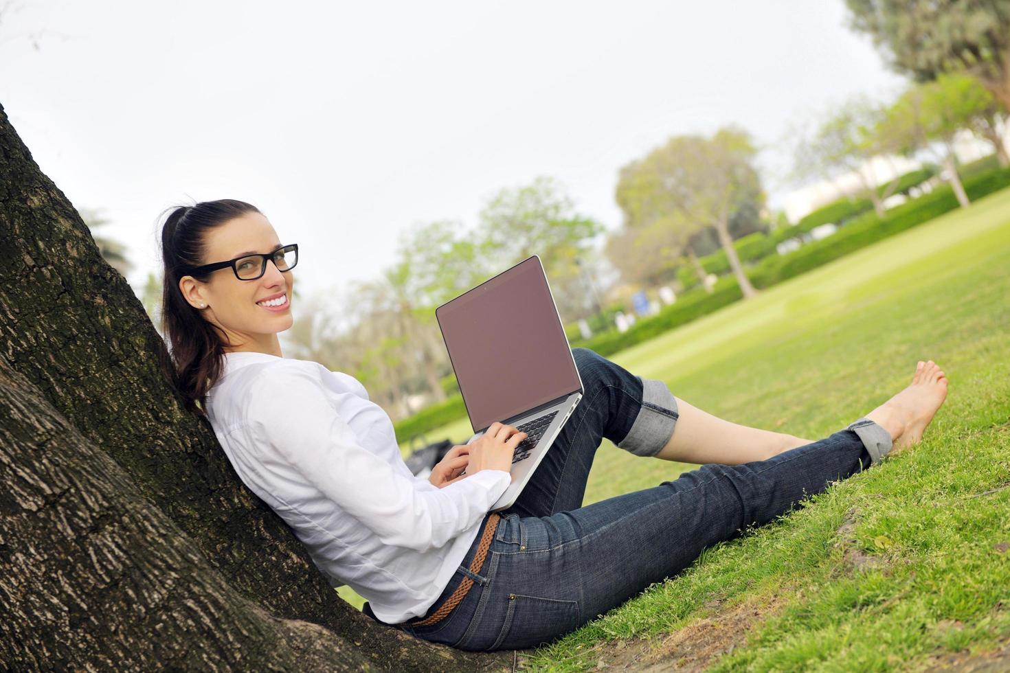 woman with laptop in park photo