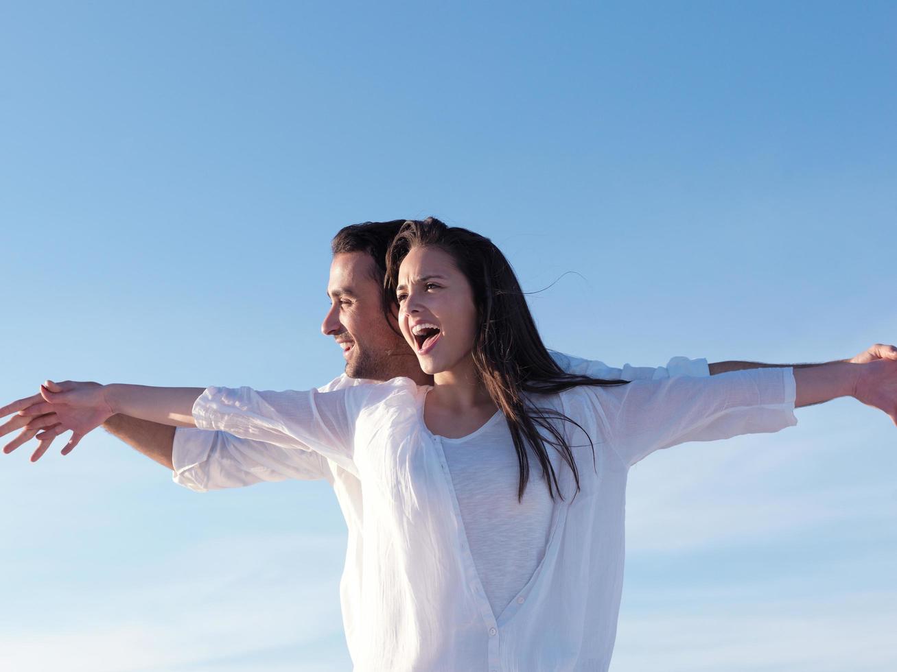 young couple  on beach have fun photo