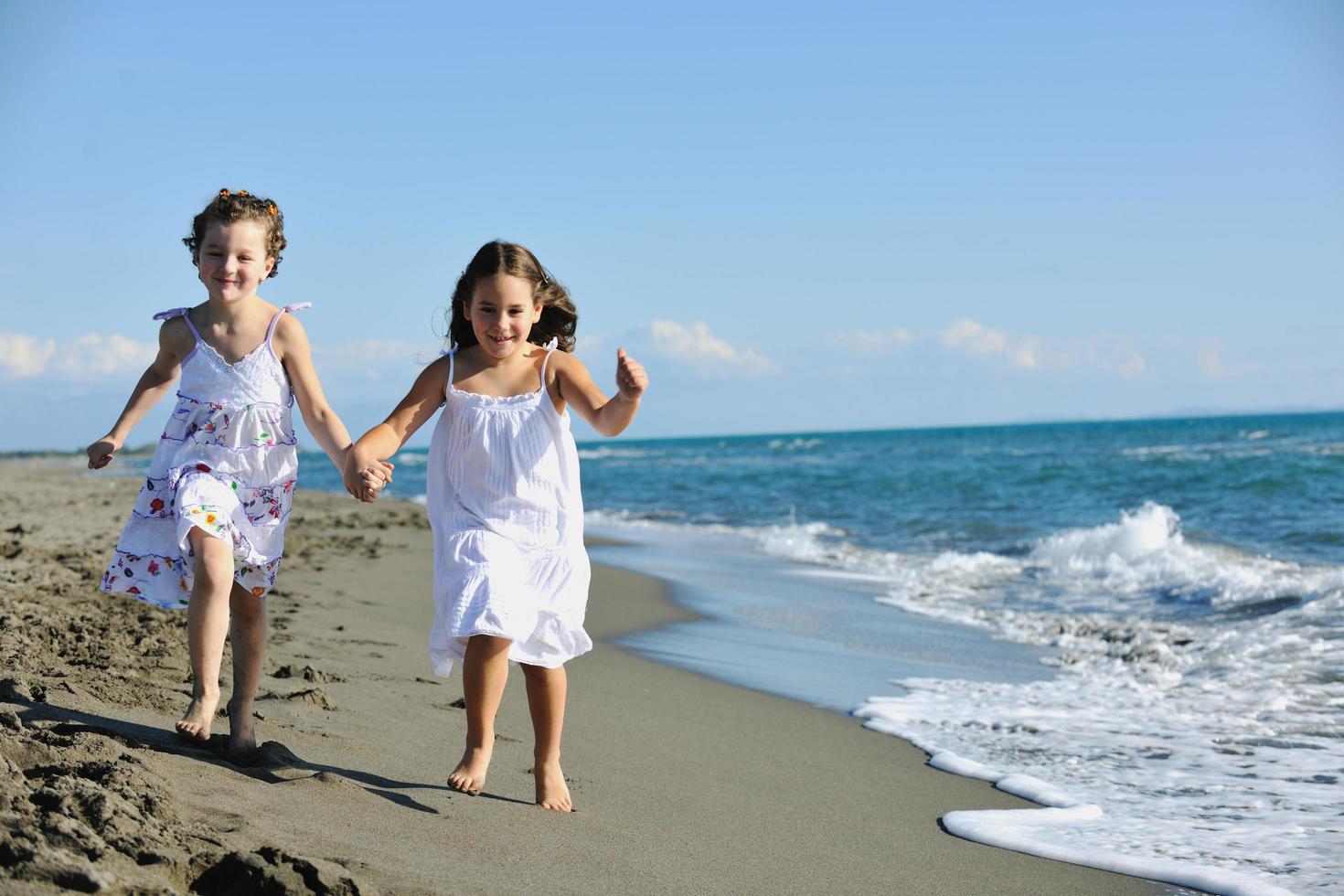 cute little girls running on beach photo