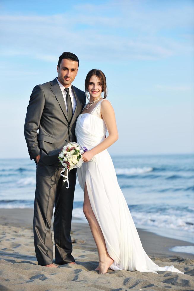 romantic beach wedding at sunset photo