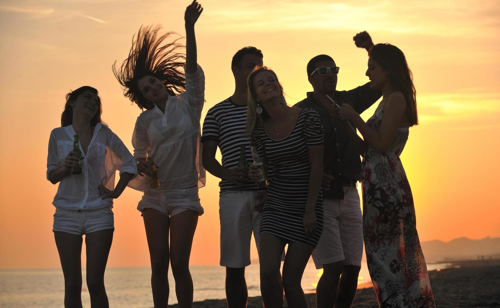 Group of young people enjoy summer  party at the beach photo