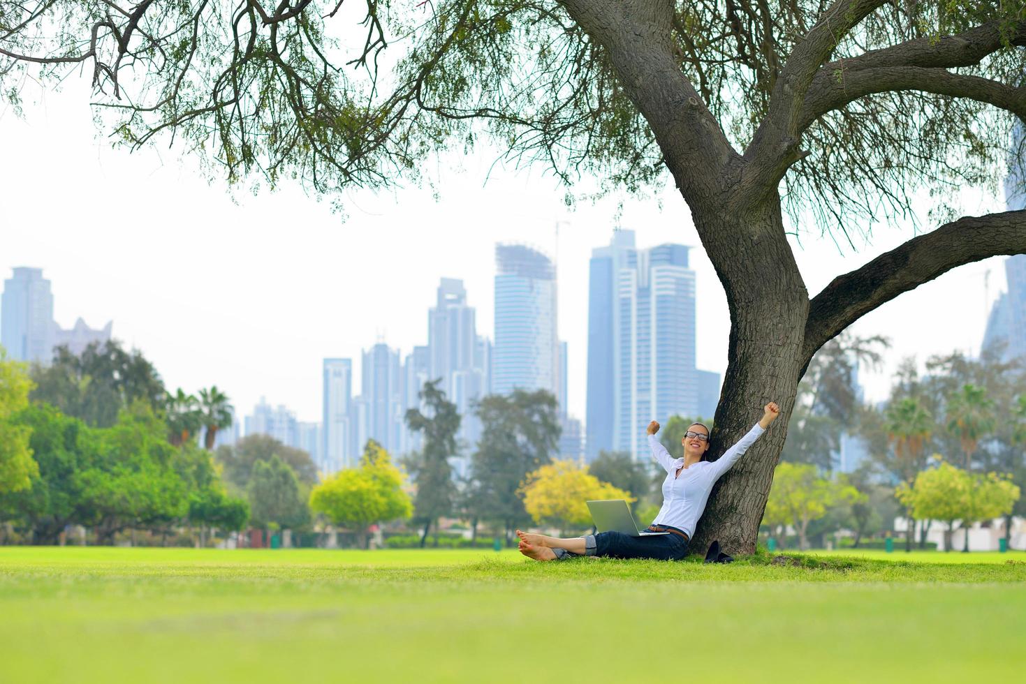 woman with laptop in park photo