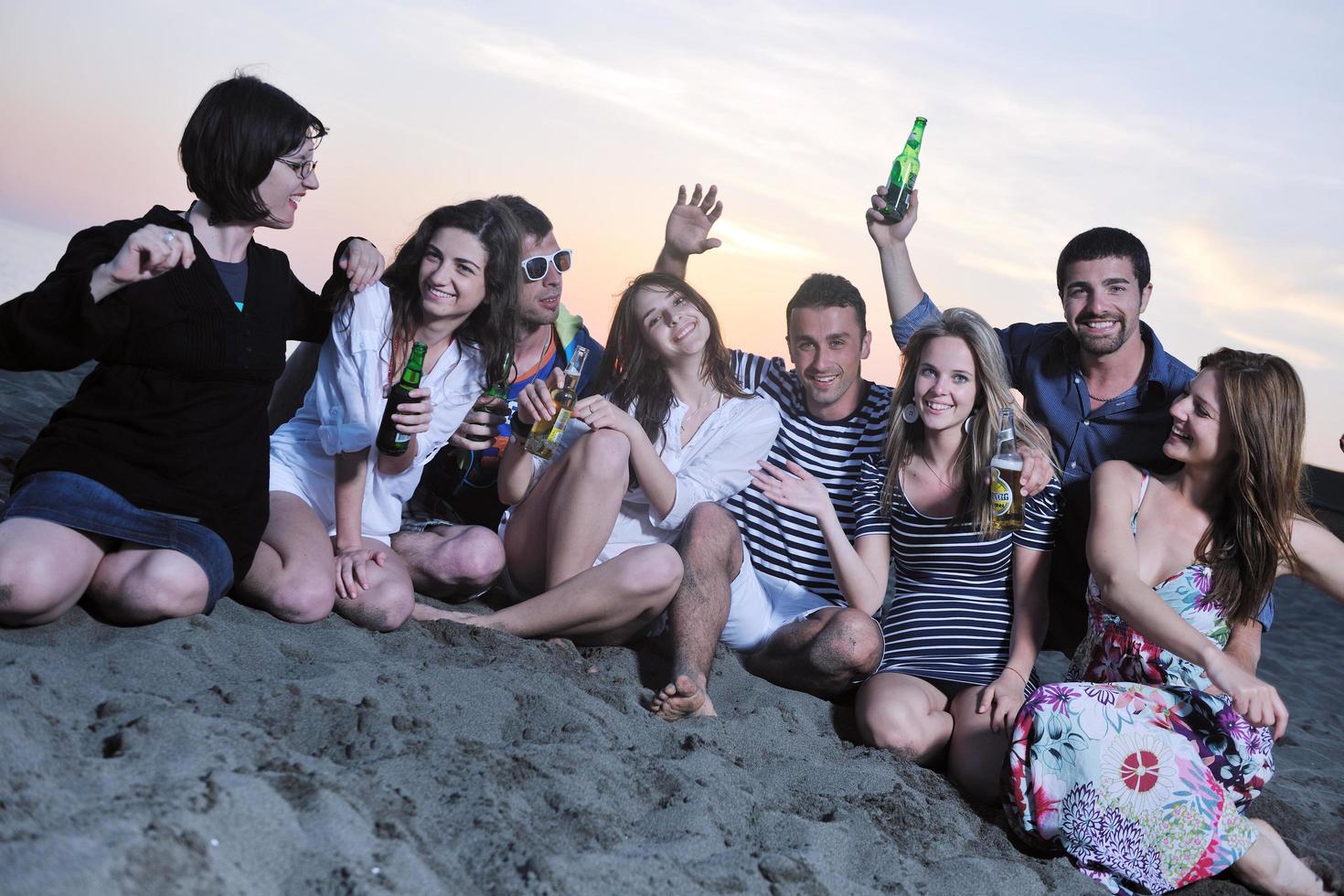 Group of young people enjoy summer  party at the beach photo