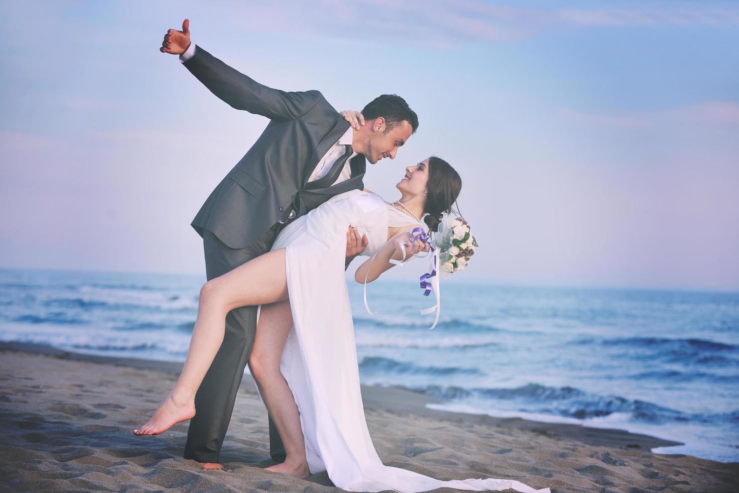 romantic beach wedding at sunset photo