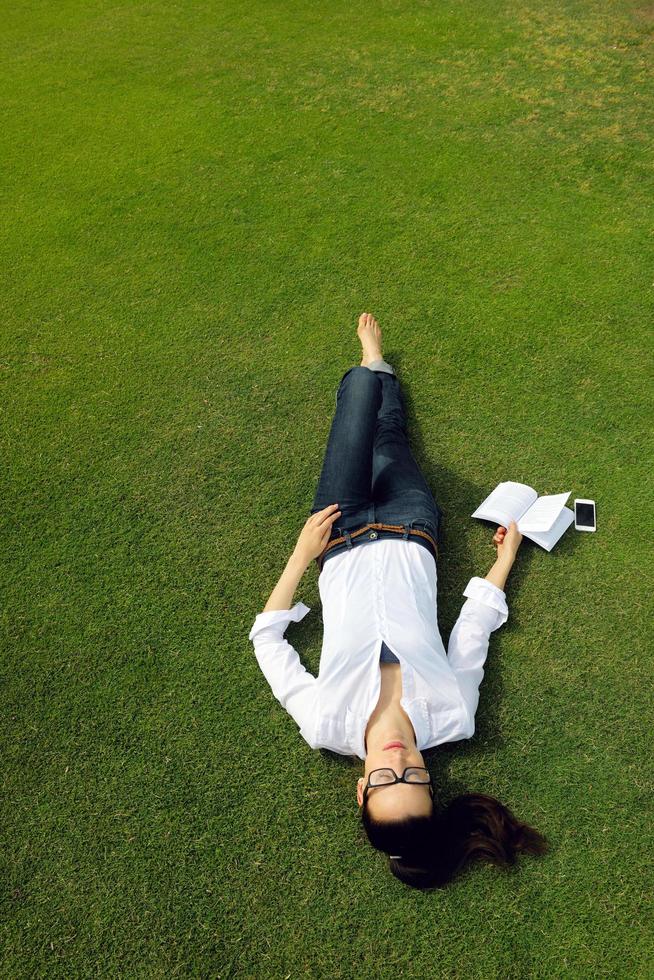 Young woman reading a book in the park photo